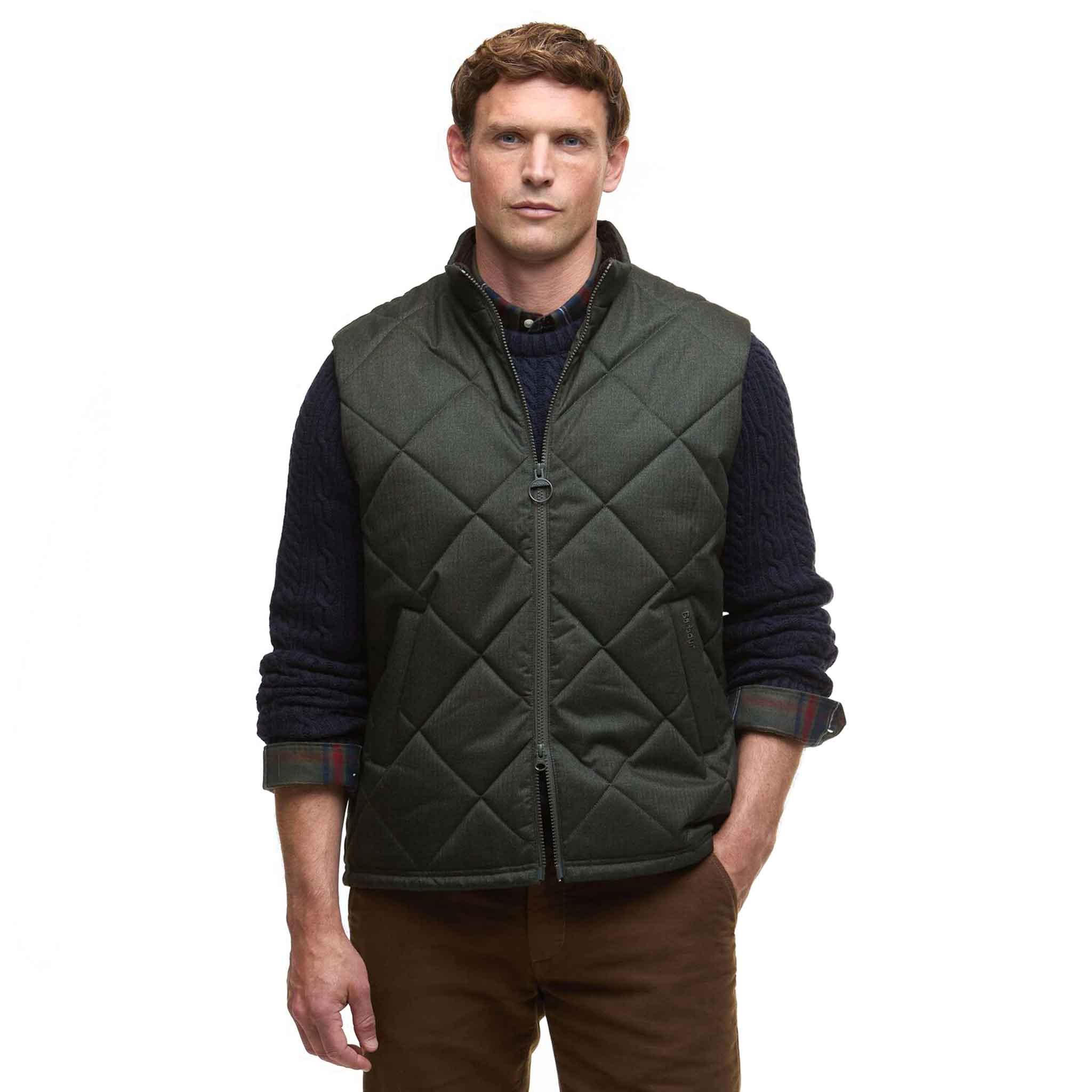 Man wearing a green quilted vest on a white background